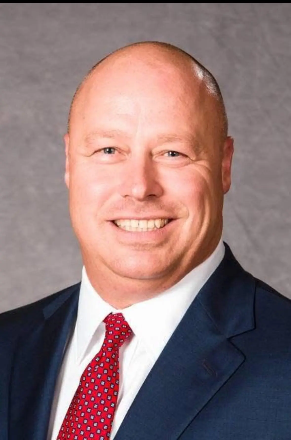 man with red tie and white shirt headhsot