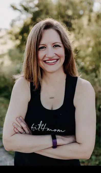 mom posing with tree in background