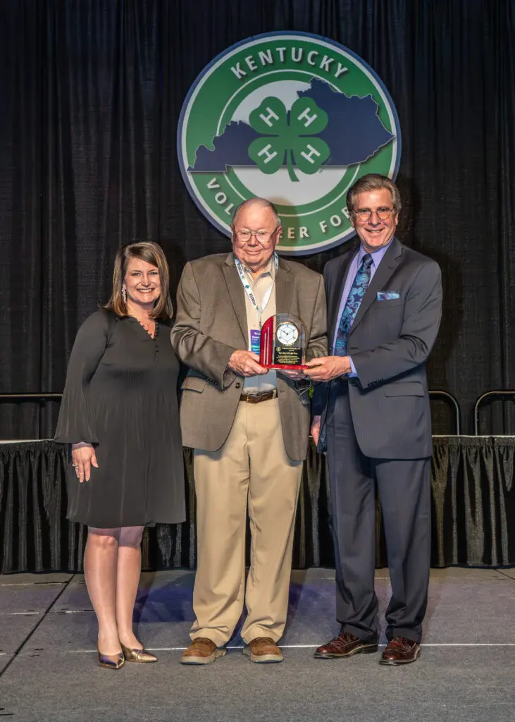 Melissa Miller and Dr. Ken Culp presenting Wayne Hunt with the Friend of 4-H Award.