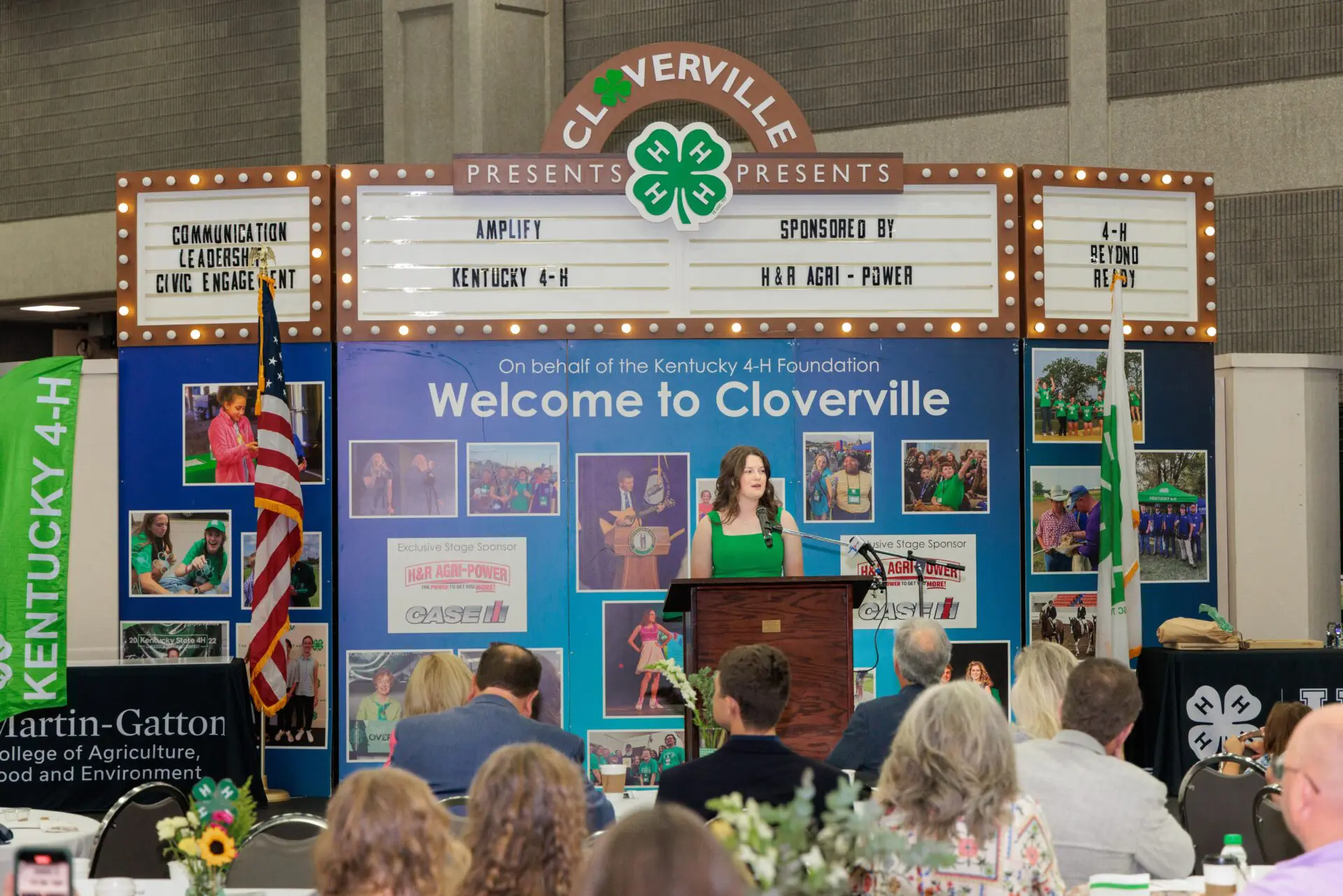 Kate Ford speaking on the Cloverville stage, at the annual donor appreciation breakfast.