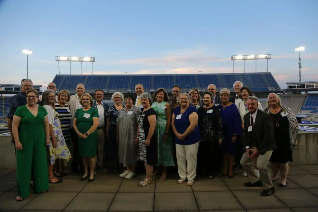 A group of 4-H STC Alumni in front of Kroger Field.